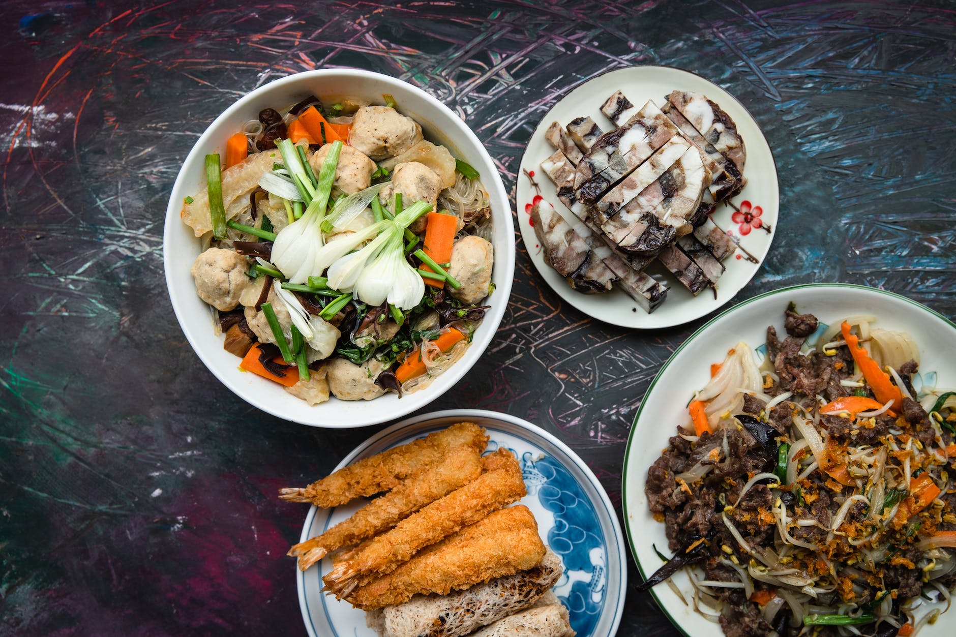 Vietnamese food dishes on white serving plates