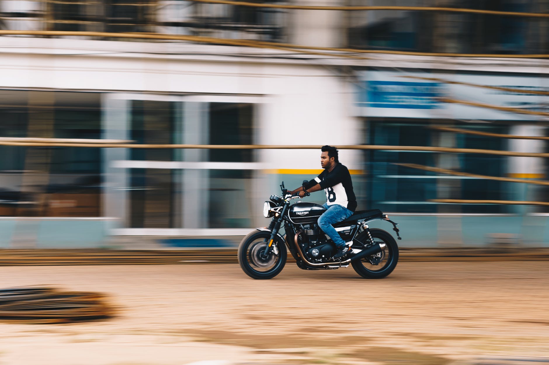 photo of man riding a motorcycle